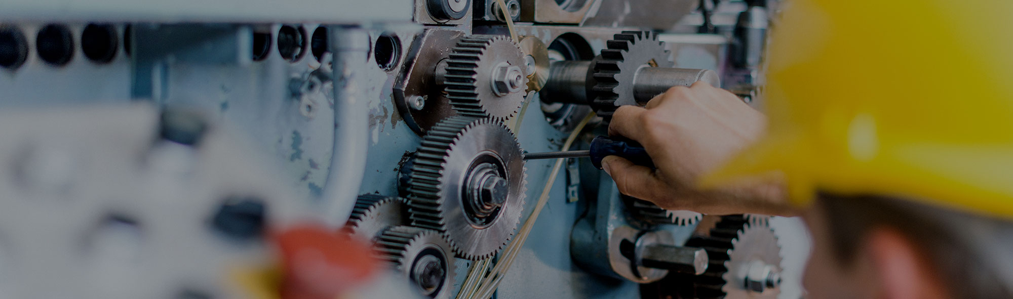 Background image of worker fixing some wheel cogs.