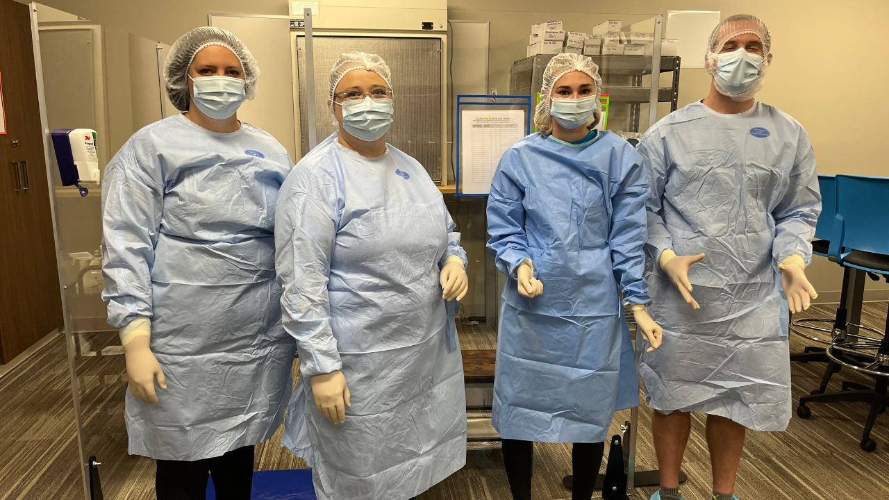 A photo of 4 students in their medical scrubs
