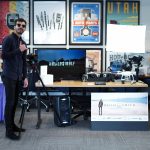 A photo of a photography booth and a man posing in front