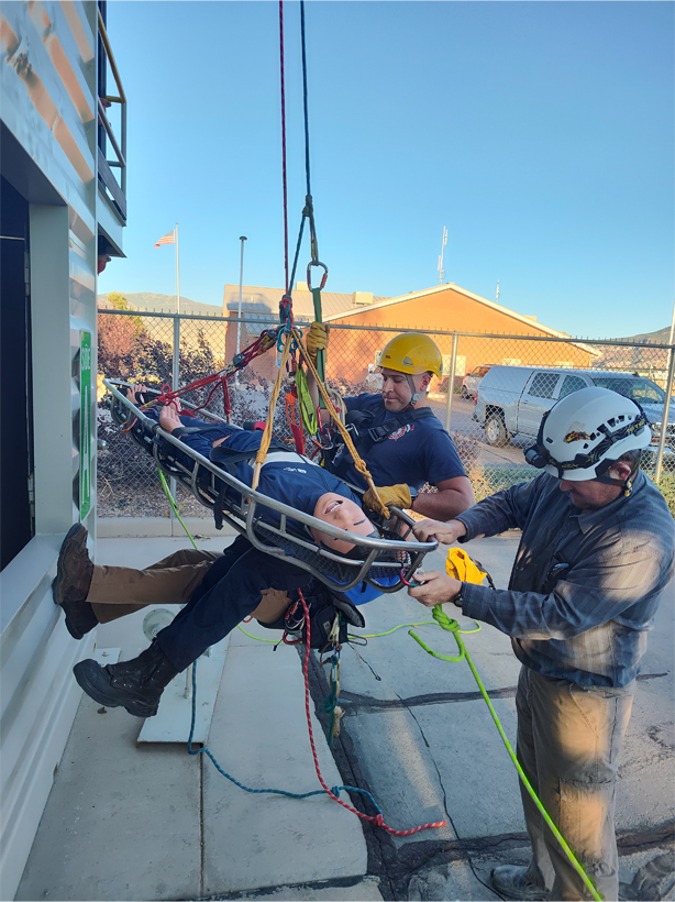 a public safety student practicing a rappelling rescue.