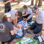 public safety personnel administering CPR.