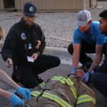public safety personnel administering first aid.
