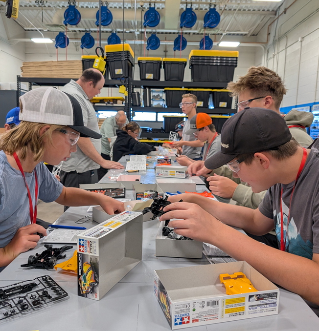 teenagers building model cars.