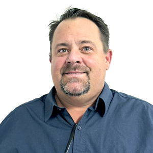 Jason Parsons smiling in a navy button down shirt against a white background.