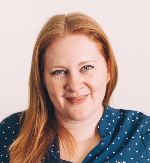 Brooke MacNaughtan smiling in a navy polka dot blouse against a light background.