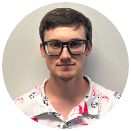 Coby Barnes in glasses and a white flamingo print shirt.